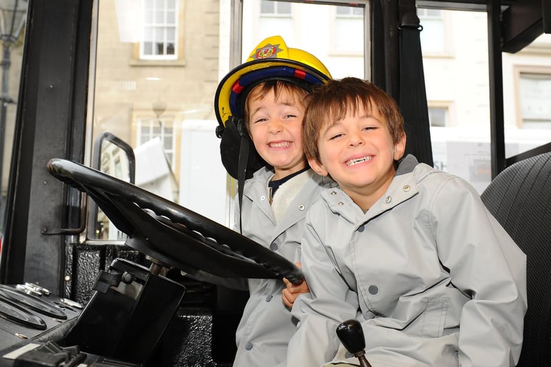 Twins Kieran and Ryan McGuire, age 5, inside a fire engine.