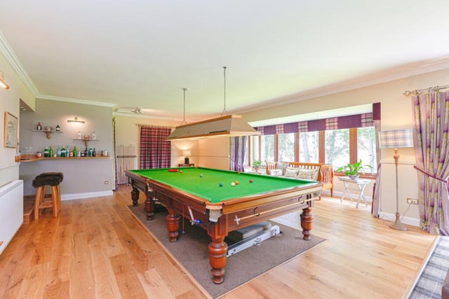 The billiard room features French doors to the garden, picture windows, home bar area, and a rear door.