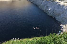 Derbyshire Fire and Rescue Service took this picture of a man swimming in the toxic water at the disused quarry.