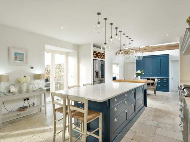 There is a spacious open-plan kitchen, dining and living space, perfect for family gatherings and entertaining