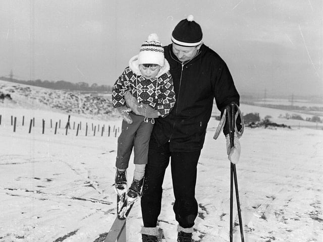 A dad gives his child a lift at Hillend in 1964.