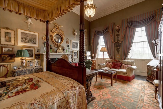The master bedroom benefits from large windows which floods the room with natural light, a four poster bed, beautiful mantle piece and stunning light fixtures