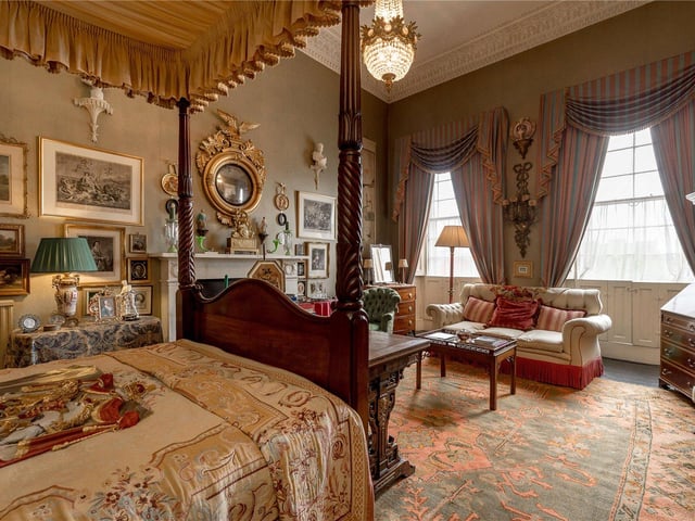 The master bedroom benefits from large windows which floods the room with natural light, a four poster bed, beautiful mantle piece and stunning light fixtures