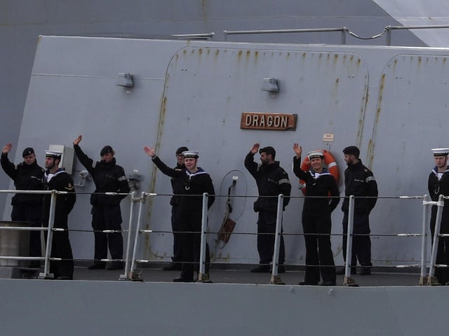 A wave from crew members
