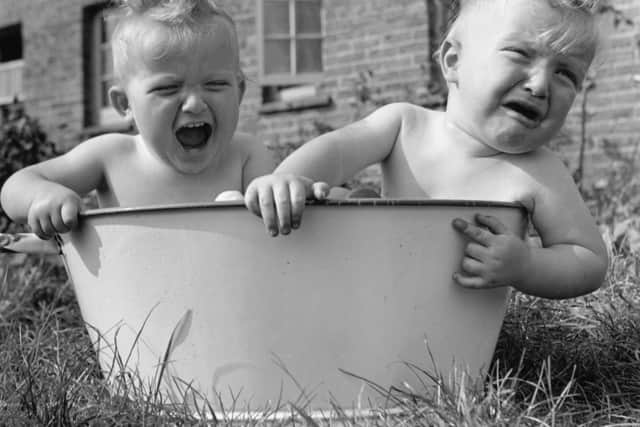 Bath time fun and tears for young twins Martin and Peter Thompson