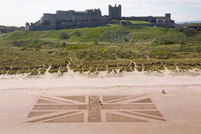 Bamburgh Castle marked 75 years since the end of war in Europe by carving out a supersize Union flag into the beach below, created by castle maintenance manager Andrew Heeley.