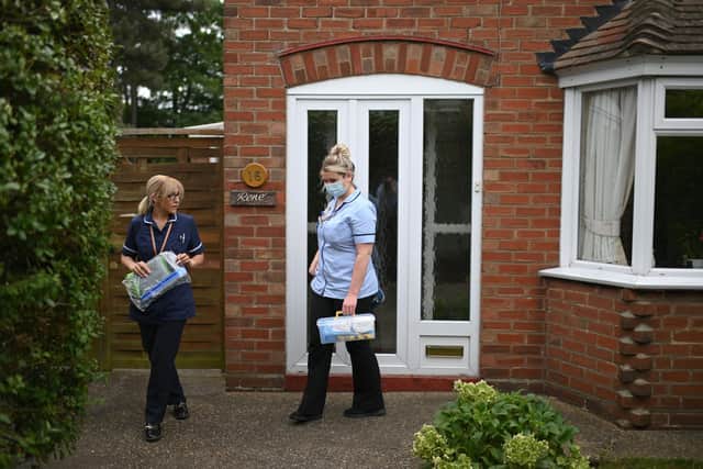 District nurses Rebecca McKenzie (R) and Emma Fiello leave the house of 86-year-old patient (Photo by Daniel Leal-Olivas - Pool/Getty Images)