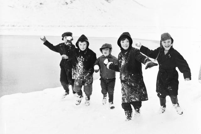 Children throwing snowballs at the photographer in Holyrood Park, Edinburgh, during their winter mid-term break in February 1966.