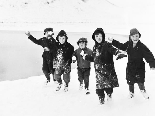 Children throwing snowballs at the photographer in Holyrood Park, Edinburgh, during their winter mid-term break in February 1966.