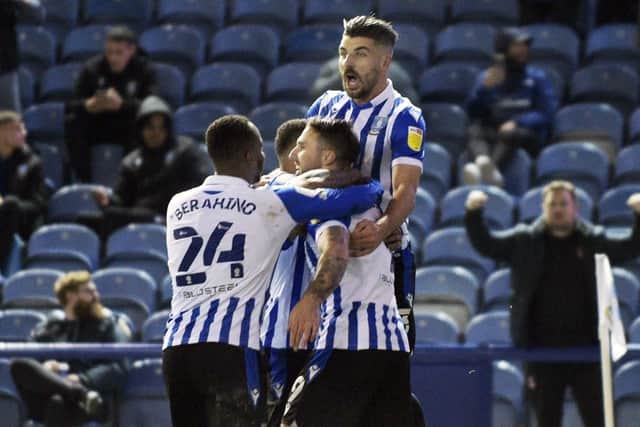 Sheffield Wednesday scorer Lee Gregory is mobbed by team-mates after slotting in his penalty.   Pic Steve Ellis
