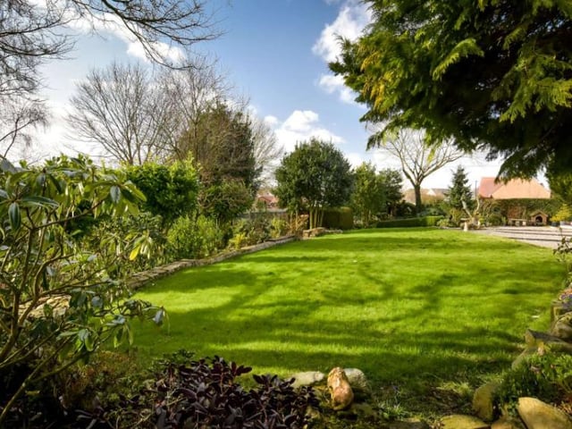 The gardens are described as a “particular feature” of the property, which is filled with plants and shrubs which produce colour throughout the garden at different times during the year