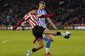 Reda Khadra of Sheffield Utd runs through Michal Helik of Huddersfield Town during the Sky Bet Championship match at Bramall Lane (Picture: Andrew Yates / Sportimage)