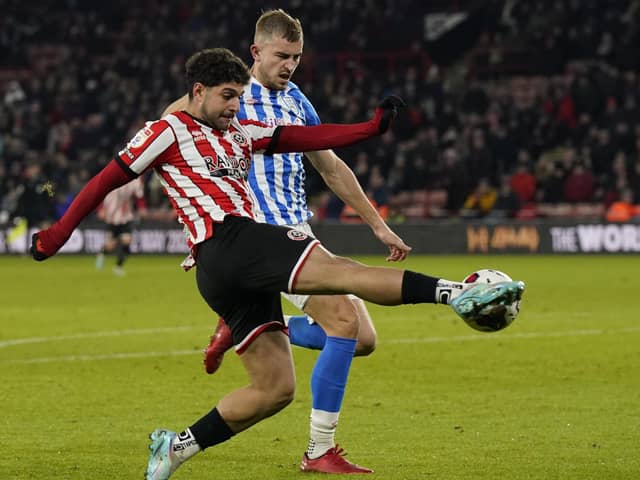 Reda Khadra of Sheffield Utd runs through Michal Helik of Huddersfield Town during the Sky Bet Championship match at Bramall Lane (Picture: Andrew Yates / Sportimage)