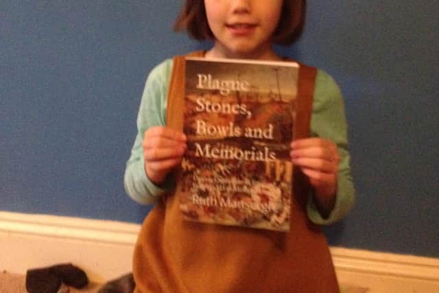 Ruth's daughter Lucy with a copy of the new book