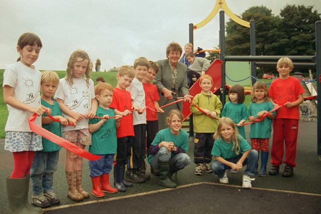 The children of Bole Hill celebrated the opening of their new playground as the ribbon is cut by Norma Haslam in 1999