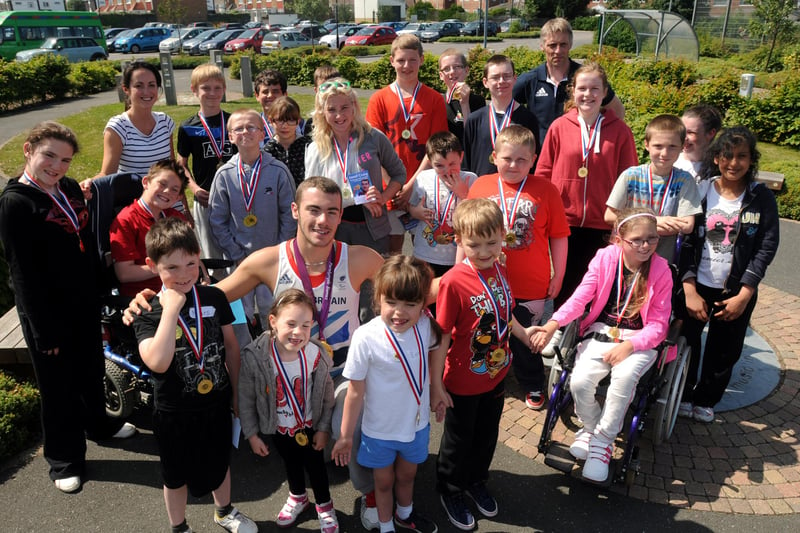Josef Craig with children from Bamburgh School with their sports day medals in 2013. Does this bring back happy memories?