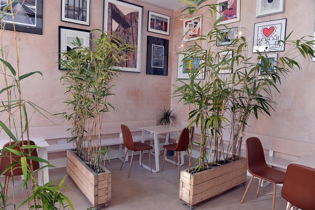 Prints line the walls, plants separate the tables and bench-style seating is on offer inside.