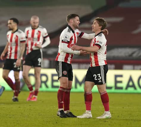 Ben Osborn of Sheffield United celebrates with teammate Oliver Norwood after victory over Aston Villa: Andrew Yates/Sportimage