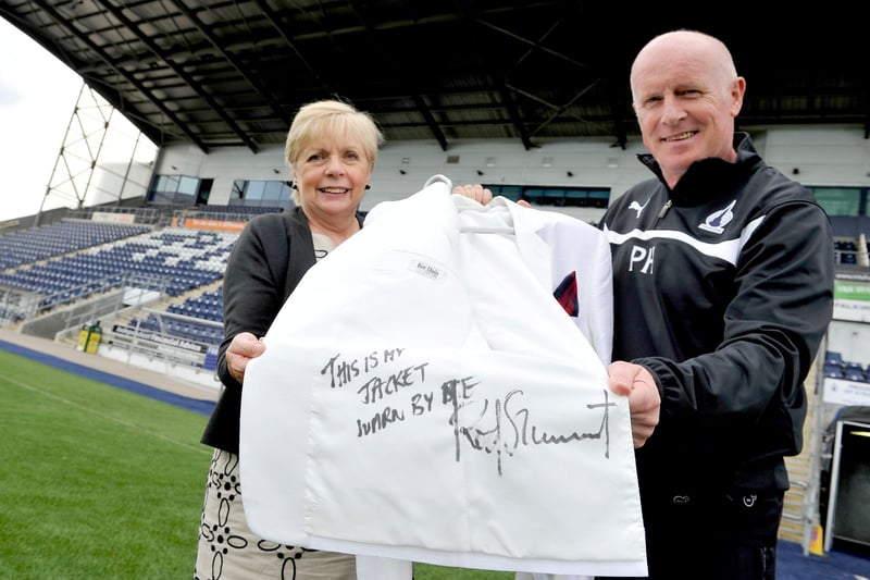 Peter Houston and Angela Gillies with Rod Stewart's white jacket to be auctioned for Strathcarron Hospice. 
(Pic: Michael Gillen)
