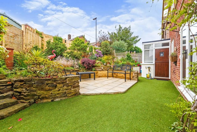 At the back of the house is a well stocked landscaped garden with paved patio area.