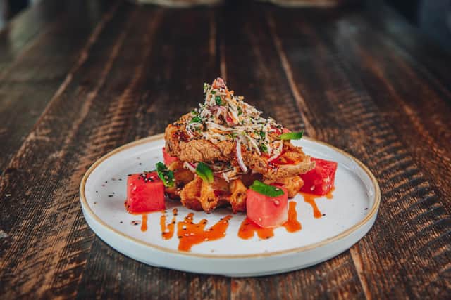 One of The Botanist's new brunch options includes the Buttermilk Fried Chicken Waffle with maple sriracha.