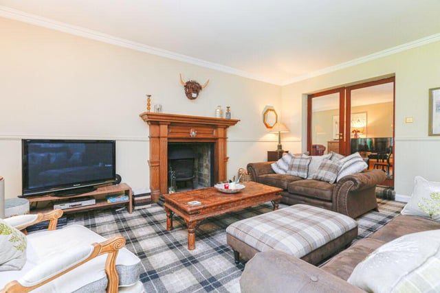 The lovely seating area in the billiard room features a large wooden fire surround with multi fuel stove.