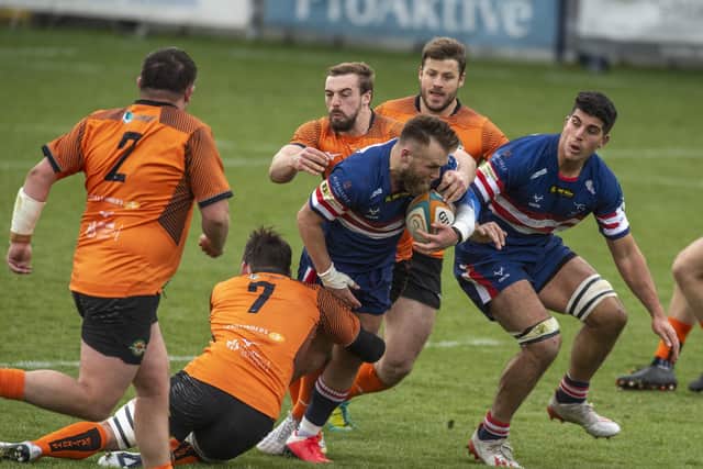 Knights' Mark Best is halted by Trailfinders' Guy Thompson. Photo: Tony Johnson