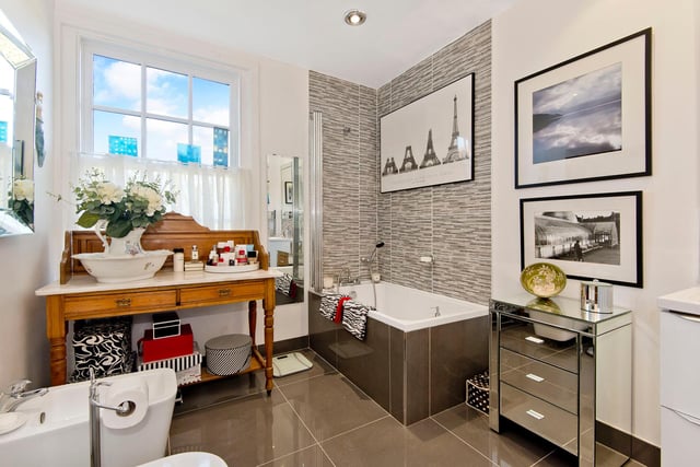 The bathroom features an attractive sunken bath with overhead shower.