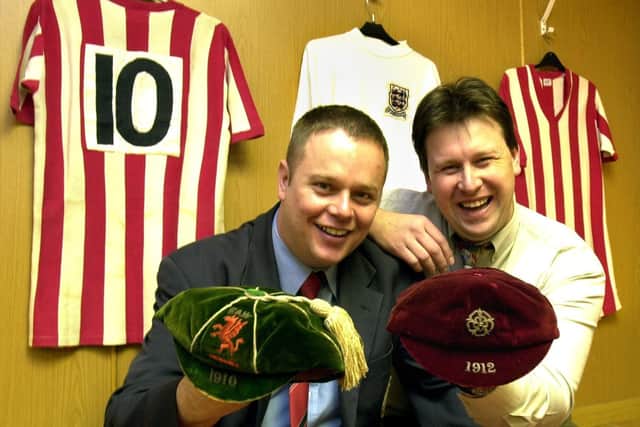A younger John Garrett surrounded by shirts worn by Tony Currie and Len Badger, holding international caps won by Bob Evans - Steve Ellis