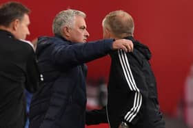 Jose Mourinho and Chris WIlder share an embrace after Sheffield United's win over Tottenham last season: OLI SCARFF/Getty