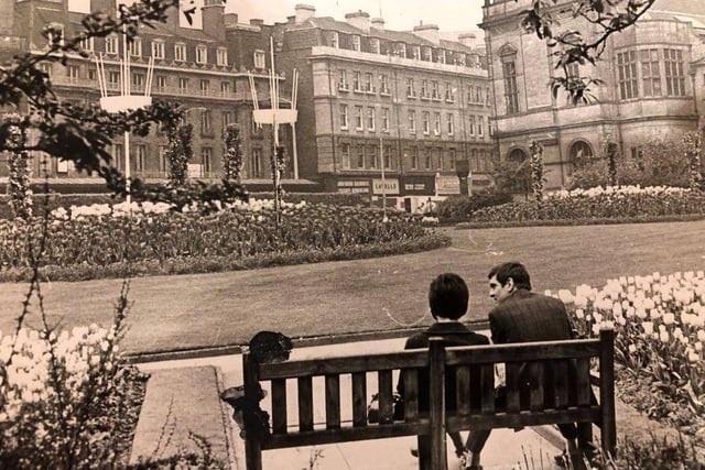 People sitting on a bench in the Peace Gardens in April 1973