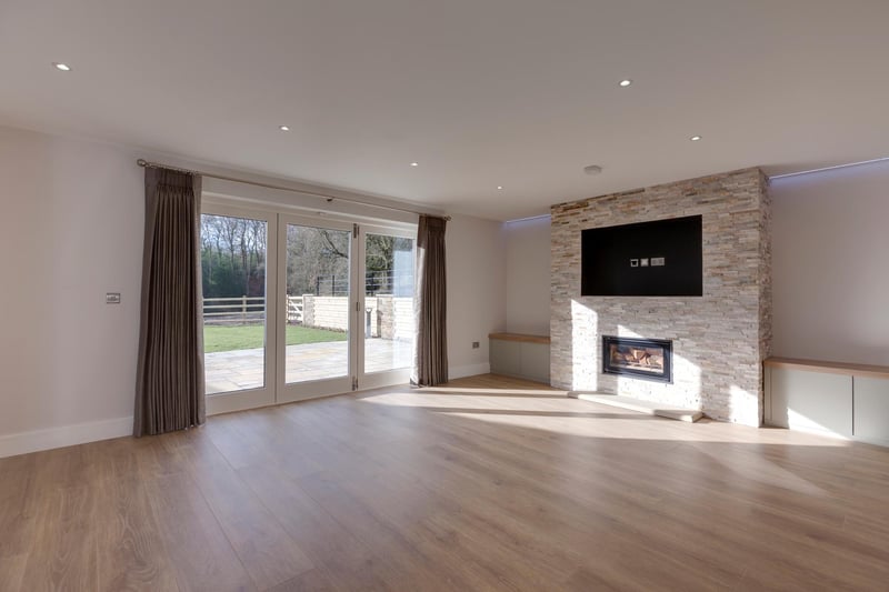 The lounge is a spacious reception room with fitted storage cupboards, data point and under floor heating. The focal point of the room is the feature wall with a Stovax log burner.