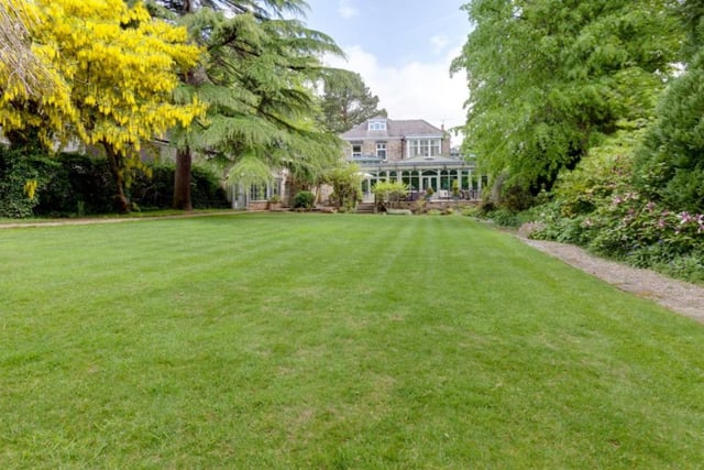 The house has an attached two-bedroomed cottage and boasts beautiful private gardens.