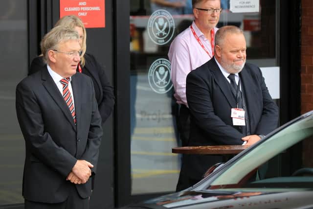 Blades legend and friend of Len Badger Tony Currie with club official John Garrett as the funeral cortege of the former Sheffield United captain passes Bramall Lane. Picture: Chris Etchells