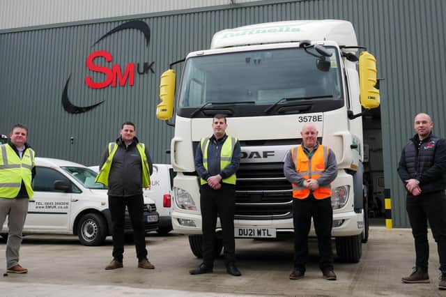 SM UK and Tuffnells staff with vehicle equipped with new safety system