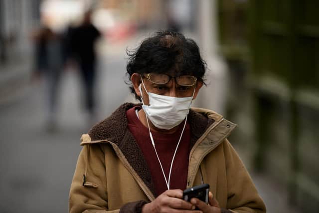 A man wearing a mask as a precaution against covid-19 (Photo by OLI SCARFF/AFP via Getty Images)