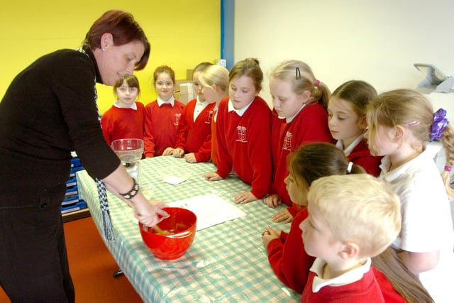 Teaching assistant Karen Qill instructing the Plains Farm Primary School lunchtime cookery club about the finer points of making chocolate muffins in 2008.