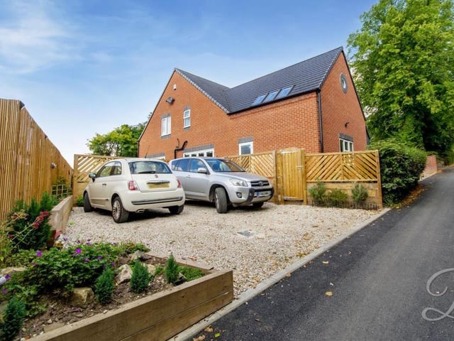 Moving outside and, as you can see, there is lots of space for parking. Two driveways are complemented by an integrated garage with an electric door.