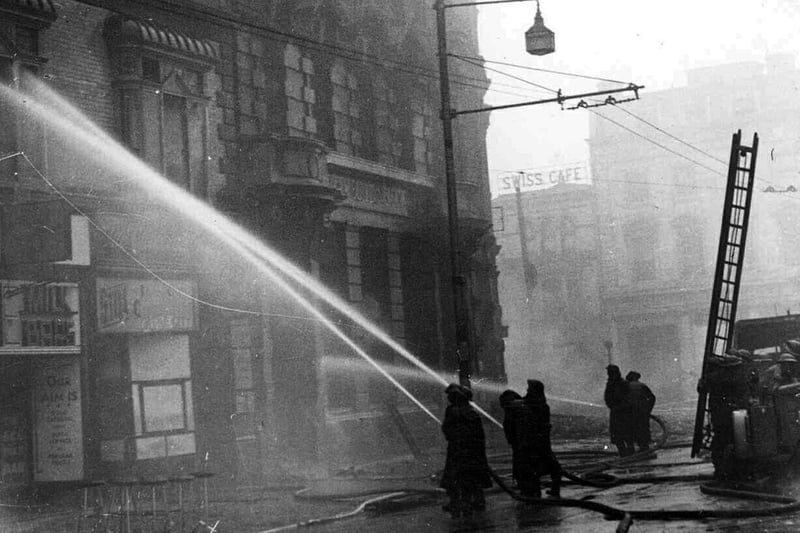 Firemen fighting blitzed buildings on the corner of Commercial Road and Edinburgh Road  January 1941.