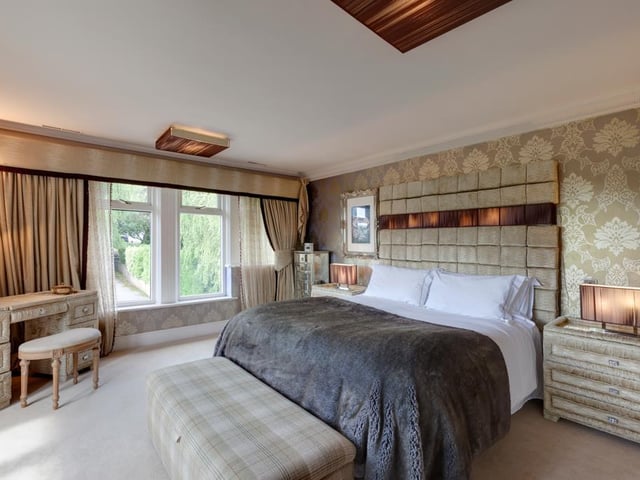 The property boasts four bedrooms in total, including this spacious master with double doors leading out onto a Juliet balcony, and a stylish en-suite bathroom with a rain head shower and spa jets.