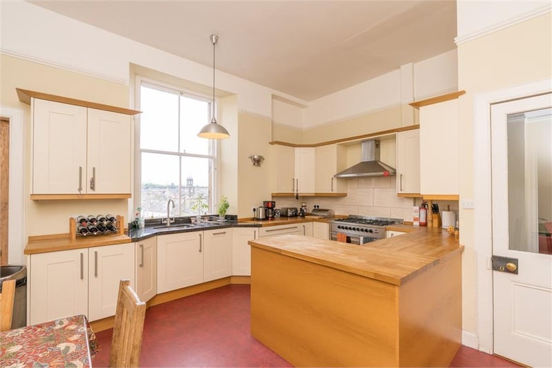The dining kitchen is a large room fitted with a range of base and wall units with wood work top, range cooker, dishwasher and fridge.