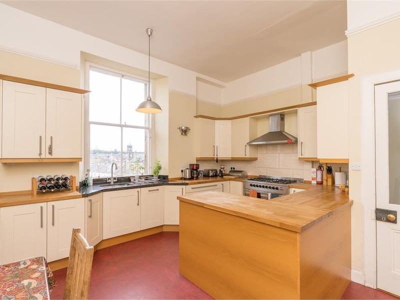 The dining kitchen is a large room fitted with a range of base and wall units with wood work top, range cooker, dishwasher and fridge.