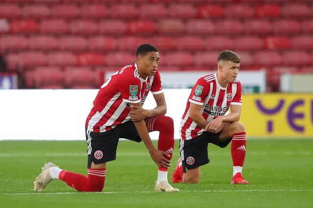 Daniel Jebbison of Sheffield United and Zak Brunt, now on loan at Borehand Wood, take a knee: Simon Bellis / Sportimage via PA Images