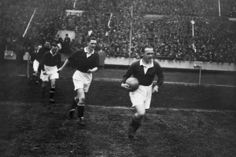 Scotland captain Jimmy McMullan leads out his team ahead of the 1928 win