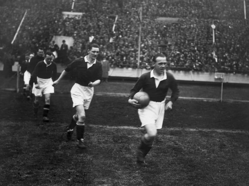Scotland captain Jimmy McMullan leads out his team ahead of the 1928 win