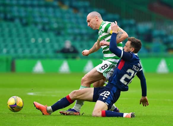 Scott Brown of Celtic and Jordan Tillson of Ross County. (Photo by Mark Runnacles/Getty Images)