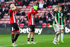 Sheffield United players react during their defeat to Brighton