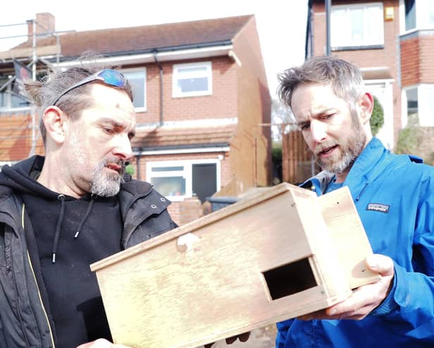 Jan Bullet and Rob Kenning (right) looking at a swift box before installation