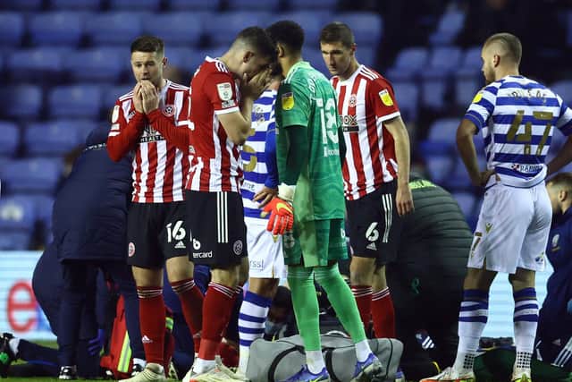 Oliver Norwood and John Egan react as Sheffield United team mate John Fleck is treated on the pitch after collapsing during the match against Reading: David Klein / Sportimage