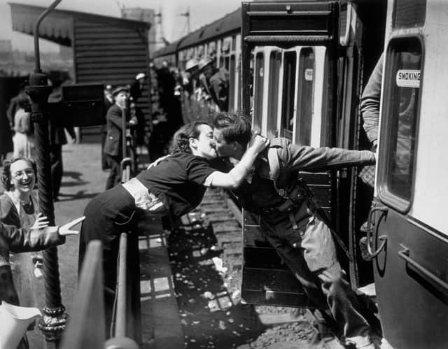 A soldier of the British Expeditionary Force, arriving back from Dunkirk, is greeted affectionately by his girlfriend.   (Photo by Topical Press/Getty Images)